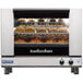 A Moffat Turbofan single deck commercial convection oven with food cooking inside.