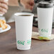 Two EcoChoice white paper hot cups of coffee on a table.