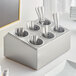A Choice stainless steel flatware organizer with gray perforated plastic cylinders holding silverware.
