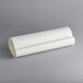 A roll of white paper on a gray surface.