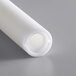 A white plastic tube with a hole in it.