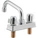A silver Regency deck-mount faucet with two gold screw handles and a 6" swing spout.