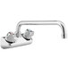 A Regency chrome wall mount faucet with silver knobs.