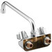 A chrome Regency wall mount faucet with two handles and a 12" swing spout.
