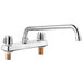 A chrome Regency deck-mount faucet with two handles and a 14" swing spout.