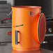 An orange cylinder with a lid.