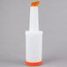 A white plastic Carlisle Store 'N Pour container with an orange spout and cap.