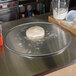 A ball of pizza dough on an American Metalcraft aluminum pizza pan.