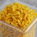 A plastic container with Barilla Rotini pasta inside.