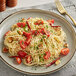 A plate of Barilla Thin Spaghetti with cherry tomatoes and herbs.