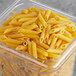 A plastic container of Barilla penne rigate pasta.