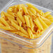 A plastic container of Barilla Pennoni Rigati pasta.