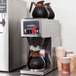 A Bloomfield automatic coffee brewer with coffee pots on top.