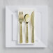 A white plastic plate with a Visions gold-plated flatware set on it.