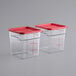 A pair of Carlisle square plastic containers with red lids.