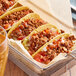 A tray of tacos filled with Hungry Planet Chorizo and sauce.
