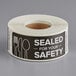 A roll of TamperSafe black paper labels with white text reading "Sealed For Your Safety"