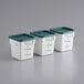 A row of Choice white polypropylene food storage containers with green lids.