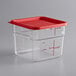 A clear square polycarbonate container with a red lid.
