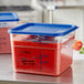 Two Vigor clear square food storage containers with blue lids on a counter.