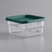 A clear plastic container with a green lid.