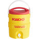 A yellow and red Igloo insulated beverage dispenser with a lid.