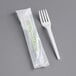 A plastic bag with a green EcoChoice label containing a package of white EcoChoice compostable forks.
