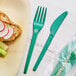 A plate of food with a green EcoChoice CPLA fork and knife.