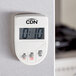 A close-up of a white CDN digital kitchen timer.