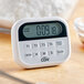 A white and black CDN digital kitchen timer on a home kitchen counter.