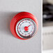 A red and white CDN MT4-R kitchen timer on a counter.