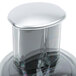 A silver and black Robot Coupe Cuisine Kit juicer lid on a glass container.