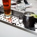 A 48" stainless steel underbar mount beer drip tray with a mug of beer and a lime.