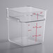 A clear square plastic container with red measurements on it.
