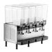 A Vollrath refrigerated beverage dispenser with four clear containers on a metal machine.