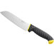 A Schraf Santoku knife with a black blade and yellow TPRgrip handle on a counter.