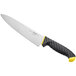 A Schraf chef knife with a yellow handle and black blade on a counter.