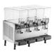 A Vollrath refrigerated beverage dispenser with four clear plastic containers with lids.