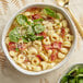 A bowl of soup with Barilla Collezione Three Cheese Tortellini and bacon.