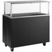 A black and silver Vollrath buffet and serving cart with a glass top on a counter.