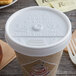 A Dart white plastic sip thru lid on a coffee cup.
