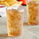 A Choice clear plastic tumbler filled with ice and iced tea.