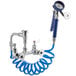 A white Waterloo pet grooming faucet with a blue coiled hose and hand held sprayer.