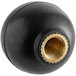 A round black handle with a gold nut.