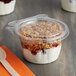 A Dart SafeSeal 8 oz. tamper-evident snack cup with a flat lid containing yogurt, granola, and fruit.