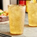 Two Choice amber plastic tumblers filled with ice and liquid.