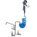 A Waterloo pet grooming faucet with a blue coiled hose and sprayer attached.