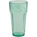 A green plastic paneled tumbler with a scalloped edge.