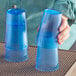 A person holding a pair of blue plastic Choice tumblers.