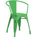 A Lancaster Table & Seating green metal outdoor arm chair with a metal back.